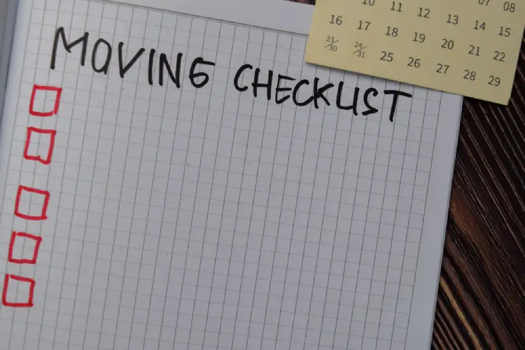 Open notebook with handwritten moving checklist and calendar, symbolizing pre-move planning for Denver residents.
