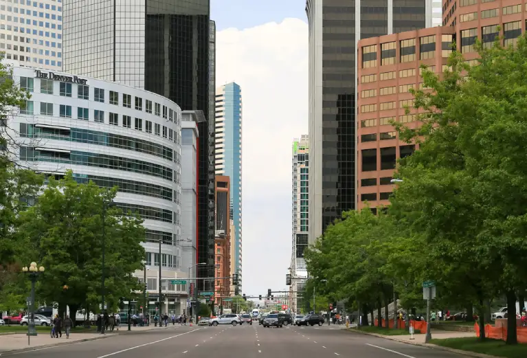 Street view of downtown Denver high-rise buildings, representing different neighborhood considerations for high-rise moves.